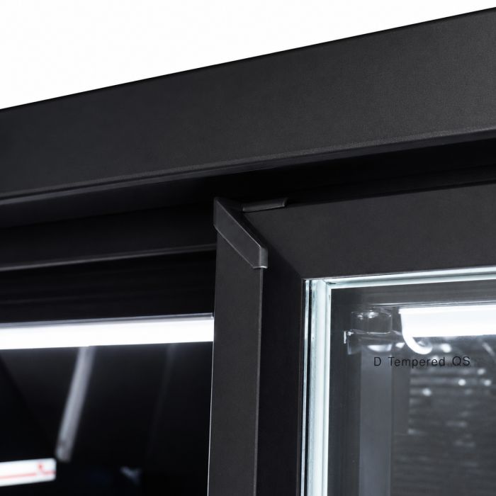 Close-up of a black metal display cabinet door frame with a glass pane and chrome trim, showing a corner joint and part of the interior.
