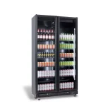Double-door commercial beverage refrigerator filled with bottles and cans on multiple shelves