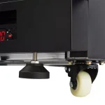 Close-up of a machine's adjustable leveling foot and a caster wheel beneath.