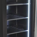 7455-1930-8-1-6a10265a60fe0 - Gastro Inventar Empty commercial refrigerator with three metal wire shelves and bright vertical LED lighting along the door side