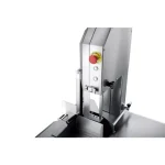 Industrial metal cutting saw with a red emergency stop button and adjustable guides on a worktable.