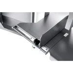 Close-up of a stainless steel industrial machine with a sliding ruler gauge and black adjustment knob