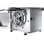 Stainless steel industrial machine with a large handwheel on the side and metal panels in view.