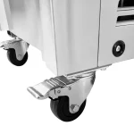 Close-up of two swivel caster wheels and a locking mechanism under a metal cart or appliance, showing the wheel hubs and mounting hardware.