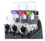 Three-tube coin sorter with transparent hoppers and colored chutes on a dark base, ready to dispense coins.